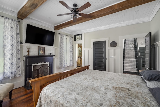 bedroom featuring ceiling fan, dark hardwood / wood-style flooring, beamed ceiling, and wood ceiling