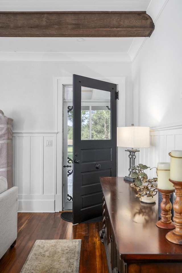 doorway to outside featuring beamed ceiling, dark hardwood / wood-style floors, and crown molding