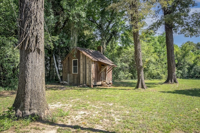 view of outbuilding with a lawn