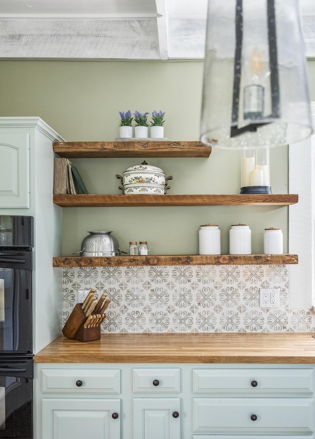 room details with white cabinets, butcher block countertops, and double oven