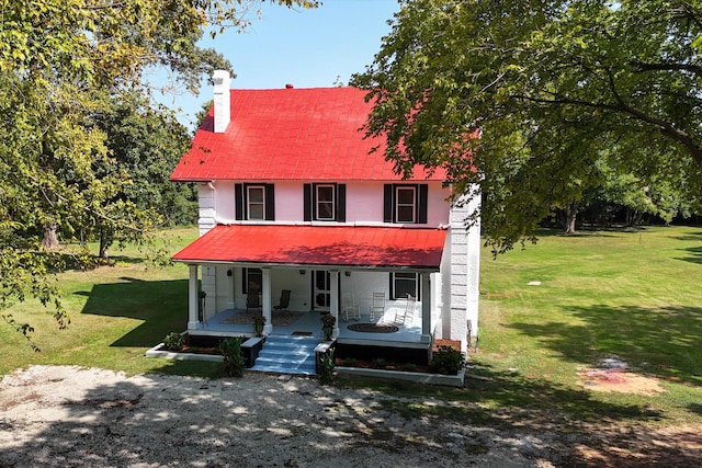 view of front of house with covered porch and a front yard