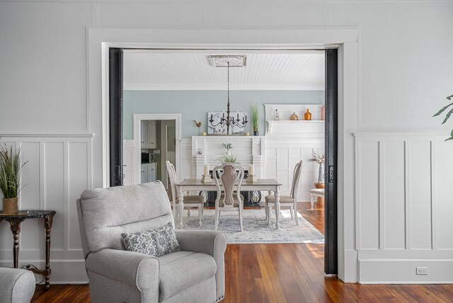 dining area with dark hardwood / wood-style flooring and a chandelier