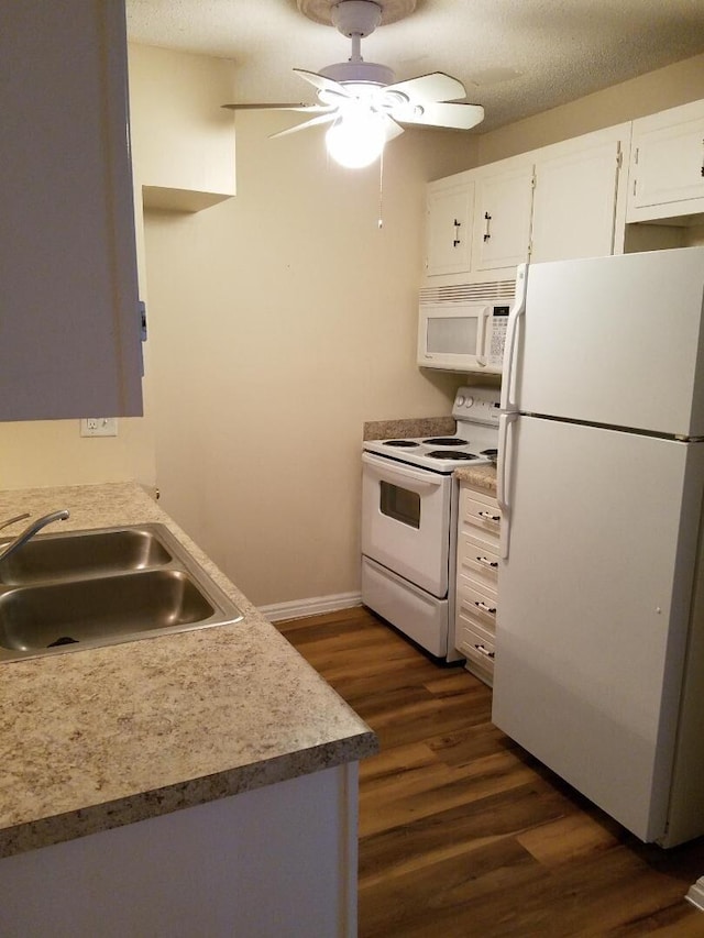 kitchen with white appliances, a textured ceiling, white cabinetry, sink, and dark hardwood / wood-style floors