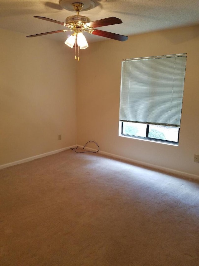 empty room with carpet flooring and ceiling fan