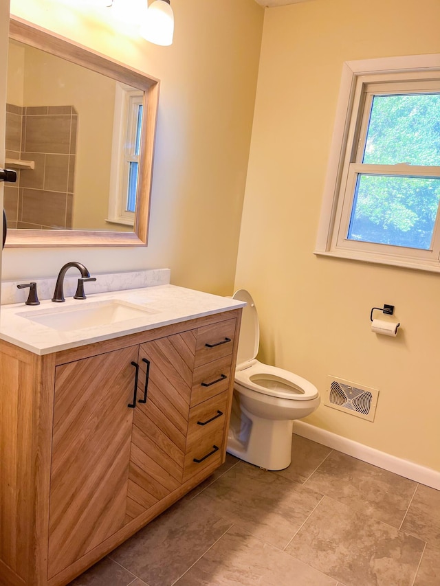 bathroom featuring baseboards, visible vents, toilet, tile patterned flooring, and vanity