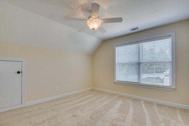 bonus room with ceiling fan, light colored carpet, and vaulted ceiling