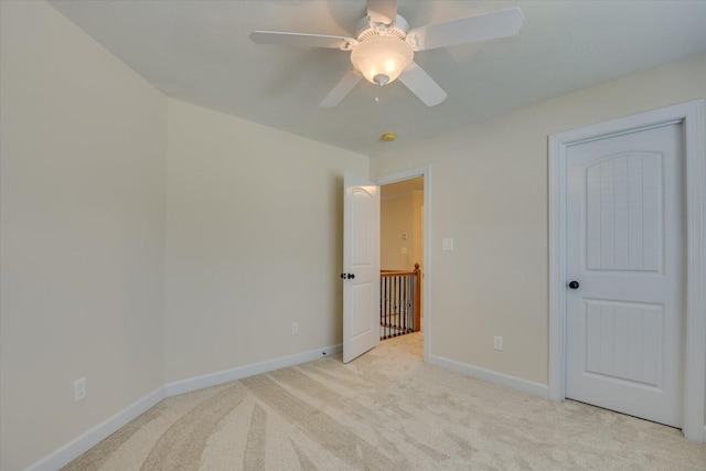 unfurnished bedroom featuring ceiling fan and light colored carpet