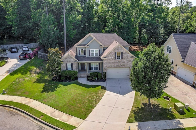 view of front of home with a porch, a garage, and a front lawn