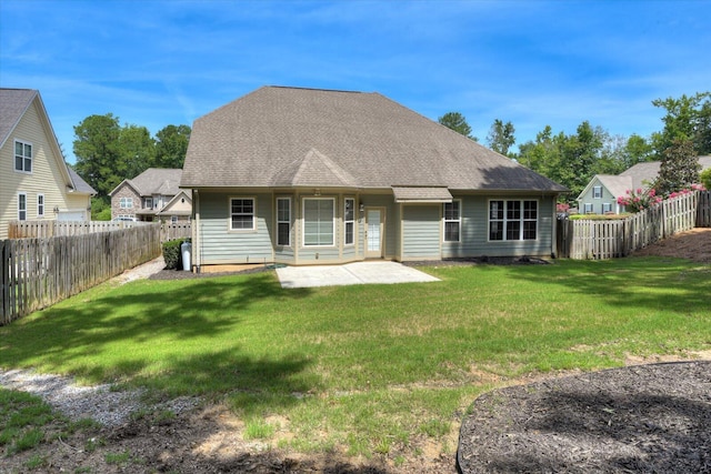 rear view of property featuring a patio and a lawn