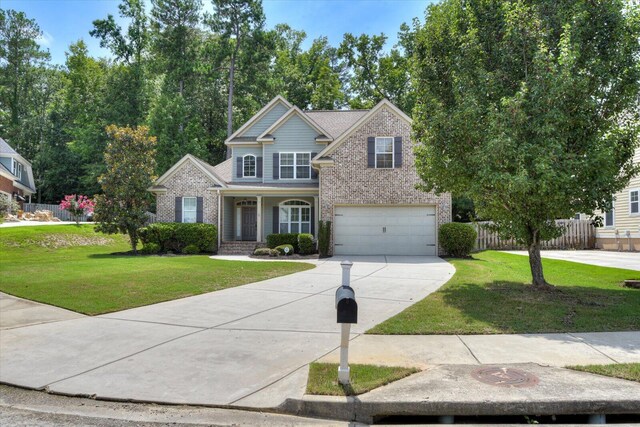 view of front of house with a garage and a front lawn