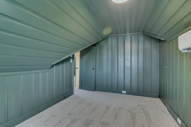 additional living space featuring a wall mounted air conditioner, vaulted ceiling, wooden walls, and carpet