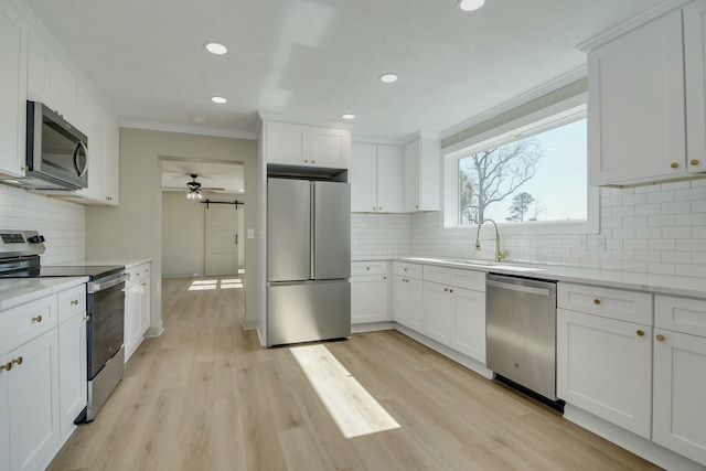 2319 Woodbine Rd, Augusta, GA 30904 - kitchen featuring stainless steel appliances, crown molding, a ceiling fan, recessed lighting, and decorative backsplash