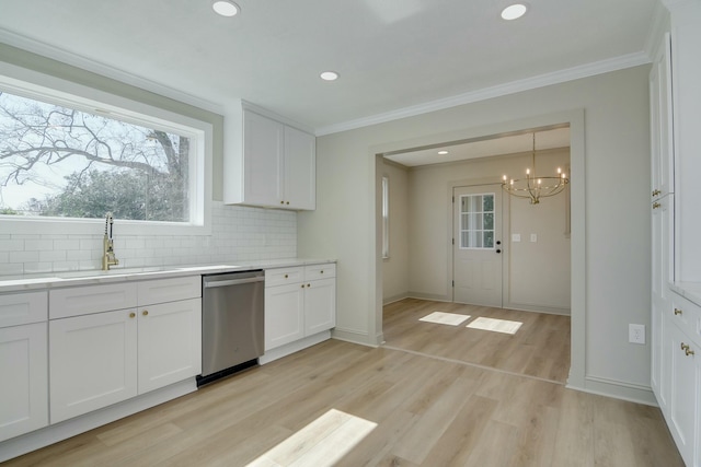 kitchen with dishwasher, white cabinets, decorative backsplash, crown molding, and light wood-type flooring