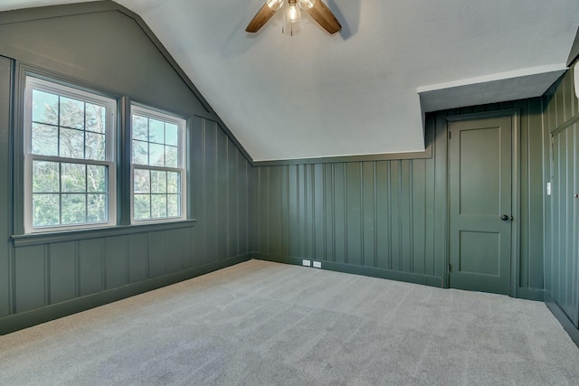 additional living space featuring lofted ceiling, carpet, and ceiling fan