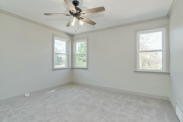 spare room featuring crown molding, light carpet, and ceiling fan