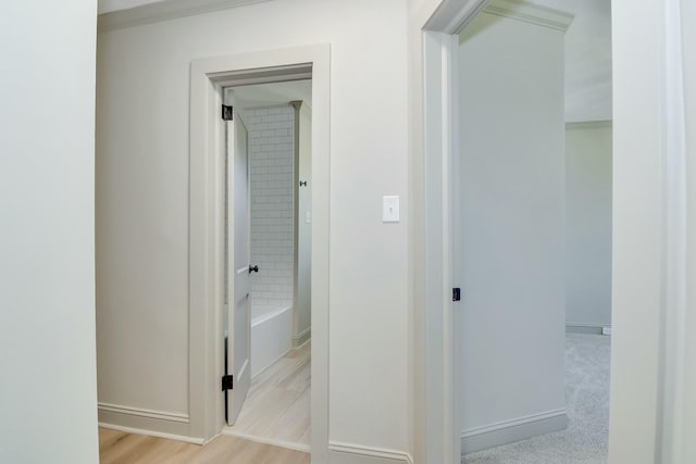 corridor with light hardwood / wood-style flooring