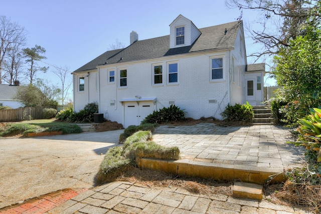 back of house with central AC and a patio