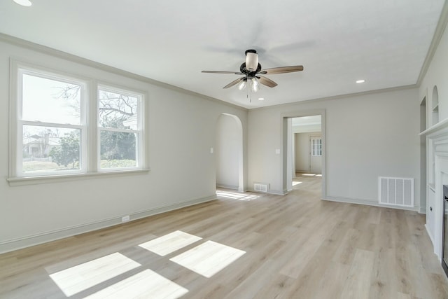 empty room featuring crown molding, ceiling fan, and light hardwood / wood-style flooring