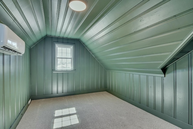 additional living space with vaulted ceiling and an AC wall unit