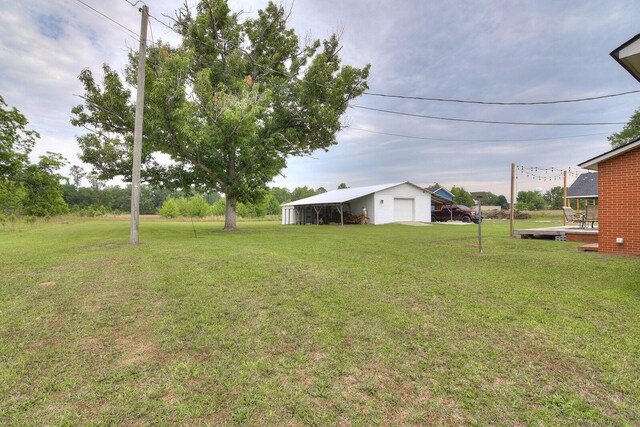 307 Terrace Hill Rd, Wrens, GA 30833 - view of grassy yard featuring a garage and an outdoor structure