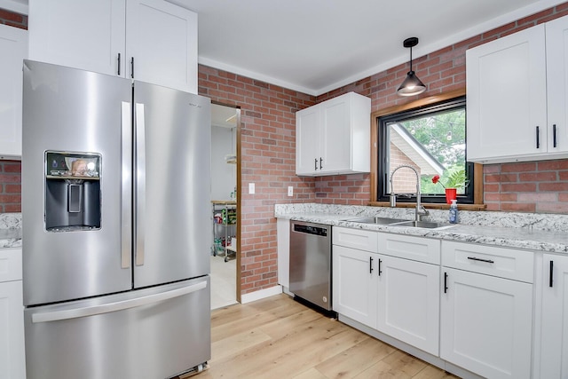 307 Terrace Hill Rd, Wrens, GA 30833 - kitchen featuring appliances with stainless steel finishes, a sink, light wood-style flooring, white cabinets, and light stone countertops