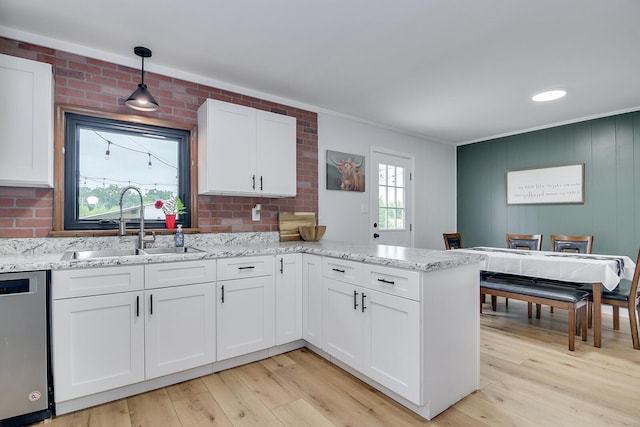 307 Terrace Hill Rd, Wrens, GA 30833 - kitchen with stainless steel dishwasher, white cabinetry, a peninsula, crown molding, and light wood-style floors