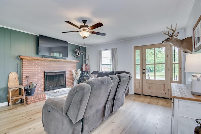 307 Terrace Hill Rd, Wrens, GA 30833 - living area with ornamental molding, ceiling fan, light wood finished floors, and a brick fireplace