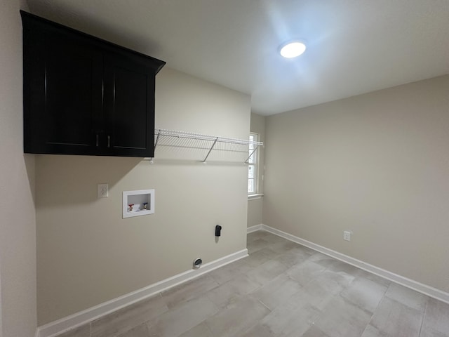 clothes washing area with washer hookup and cabinets