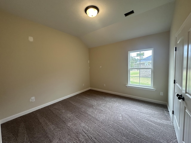 empty room with carpet flooring and lofted ceiling