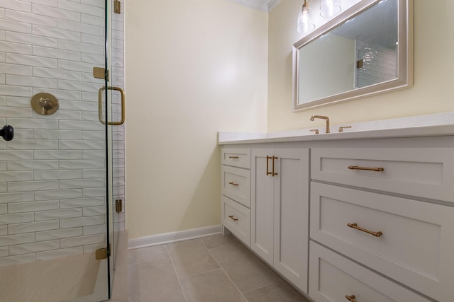 bathroom featuring a stall shower, vanity, baseboards, and tile patterned floors