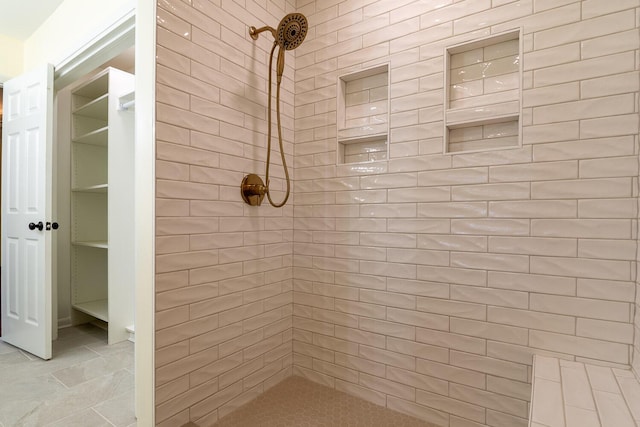 bathroom with tiled shower