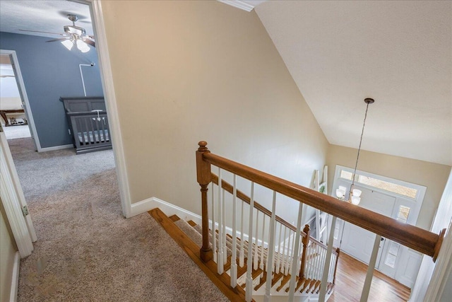 hall featuring light colored carpet and vaulted ceiling