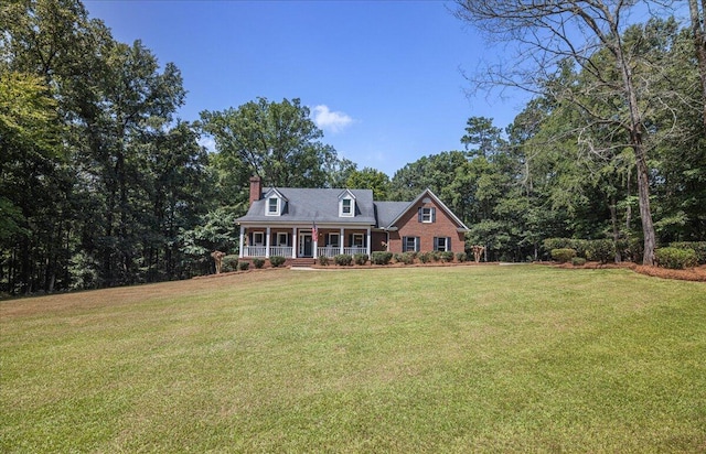 cape cod home featuring covered porch and a front lawn