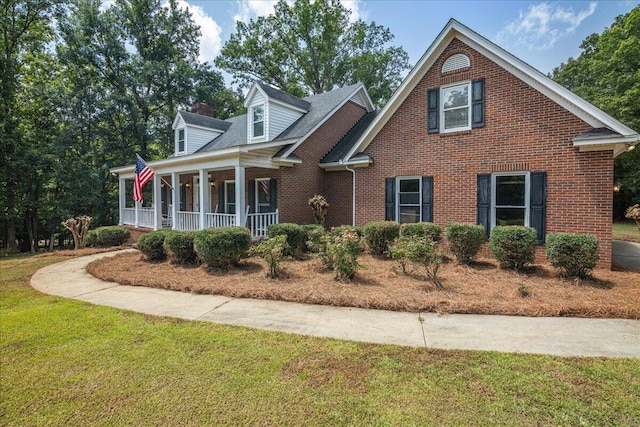 view of front facade with covered porch and a front lawn