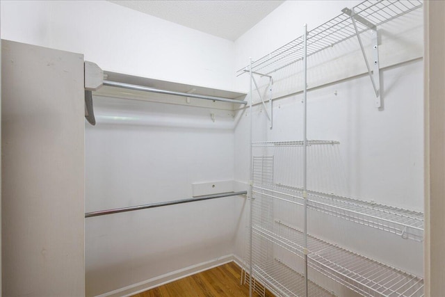 spacious closet featuring hardwood / wood-style flooring