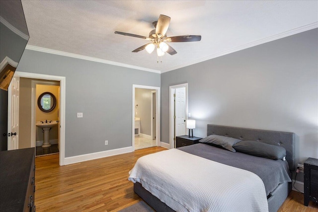 bedroom with wood-type flooring, ensuite bathroom, ceiling fan, and crown molding