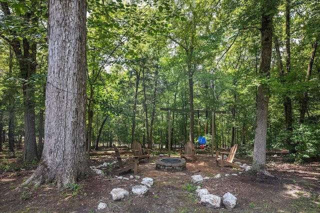 view of yard with a fire pit