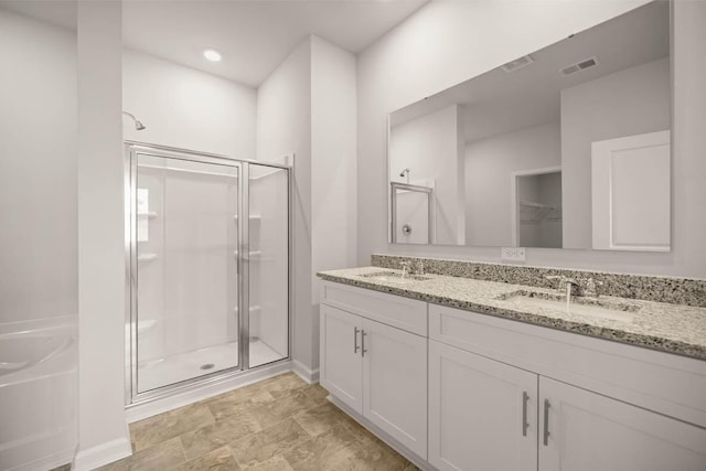 1253 Birch Cir, Grovetown, GA 30813 - bathroom with a shower stall, double vanity, a bath, baseboards, and a spacious closet
