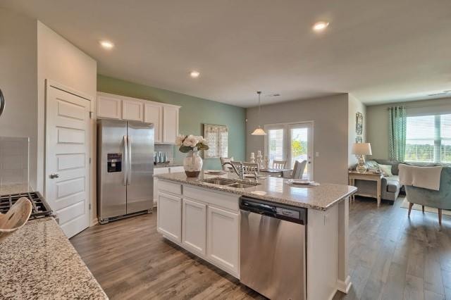 1253 Birch Cir, Grovetown, GA 30813 - kitchen with stainless steel appliances, a sink, white cabinets, wood finished floors, and a center island with sink