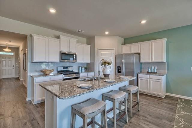 1253 Birch Cir, Grovetown, GA 30813 - kitchen with appliances with stainless steel finishes, white cabinets, light stone countertops, backsplash, and recessed lighting