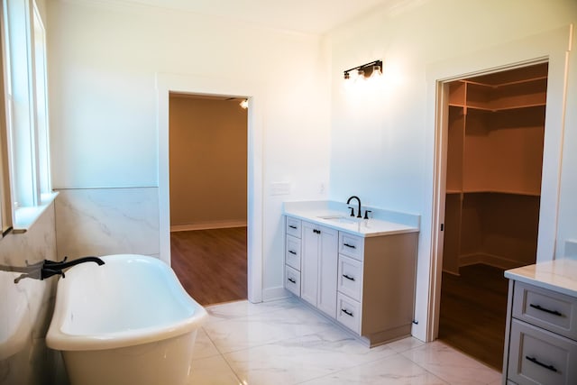 3540 Mistletoe Rd, Appling, GA 30802 - bathroom featuring marble finish floor, a spacious closet, vanity, and a freestanding tub