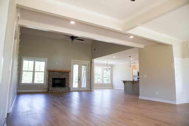 3540 Mistletoe Rd, Appling, GA 30802 - unfurnished living room featuring ceiling fan with notable chandelier, plenty of natural light, and wood finished floors