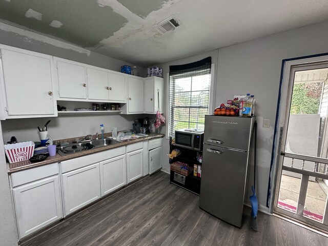 kitchen featuring white cabinets, stainless steel appliances, and dark hardwood / wood-style floors