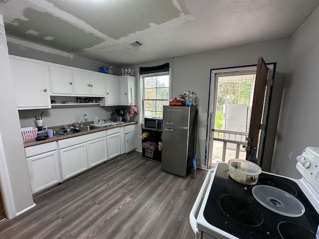 kitchen featuring white cabinets, sink, stainless steel appliances, and a wealth of natural light