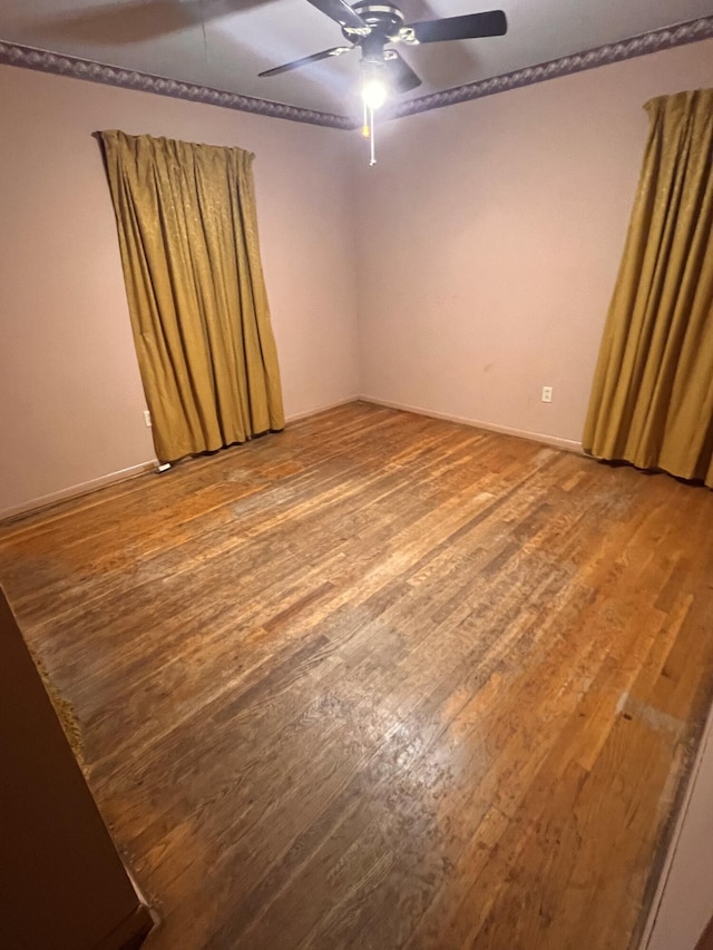 spare room with ceiling fan and hardwood / wood-style floors