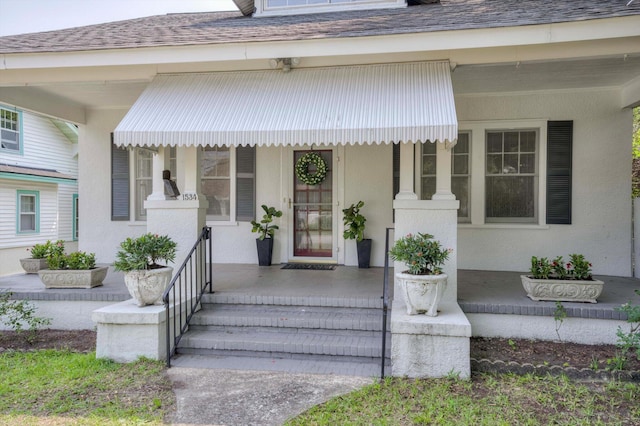 1534 Whitney St, Augusta, GA 30904 - property entrance with covered porch, roof with shingles, and stucco siding