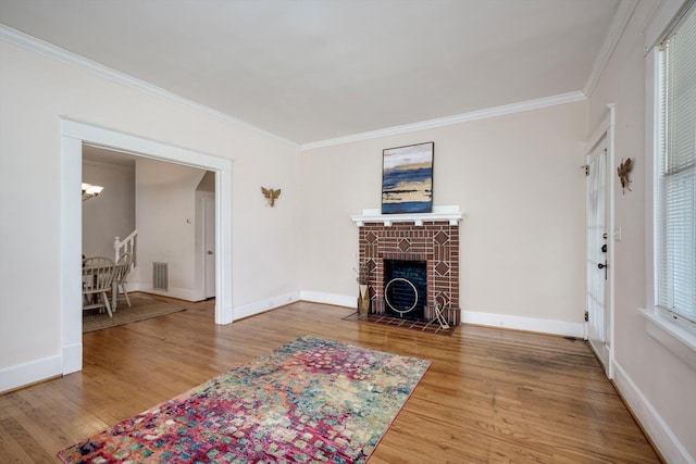 1534 Whitney St, Augusta, GA 30904 - living room featuring crown molding, wood finished floors, a chandelier, baseboards, and a fireplace