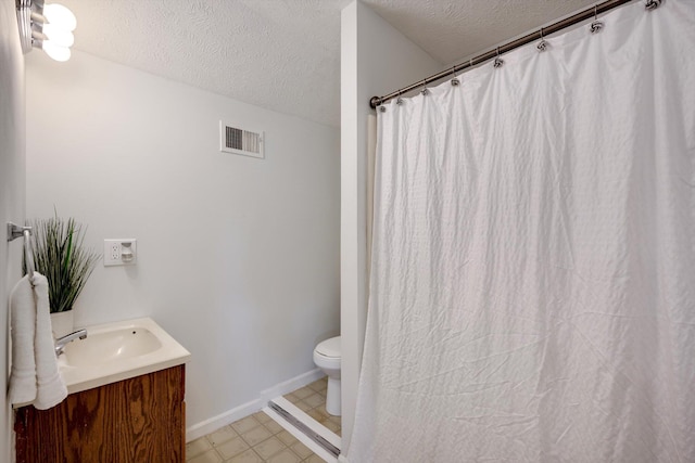 1534 Whitney St, Augusta, GA 30904 - bathroom with a textured ceiling, vanity, toilet, baseboards, and a shower with curtain
