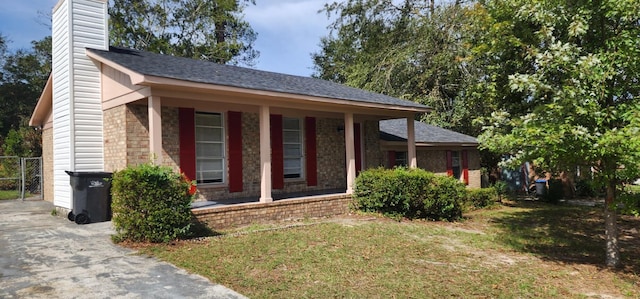 view of front of property with covered porch and a front yard