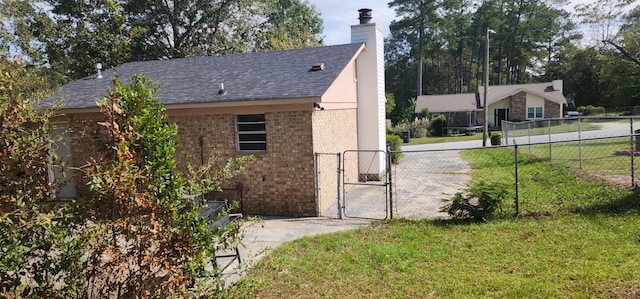 view of side of home with a yard